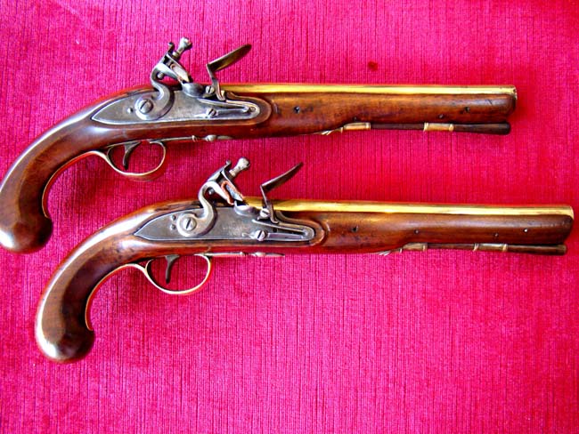 A fine pair of late 18th century brass barreled "Innkeeppers" coaching pistols inscribed "Whyte Hart, Bletchingley"